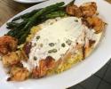 Grilled salmon with shrimp and scallops on bed of yellow rice with lemon butter caper sauce.  